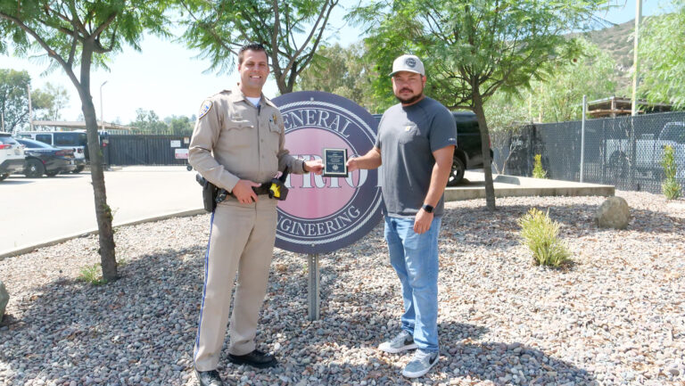 CHP Officer Jared Grieshaber presents Patriot General's Ben Garcia with a plaque.